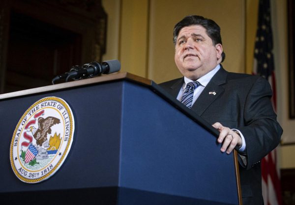 Gov. JB Pritzker speaks at a podium during a press conference at the Illinois State Capitol on Jan. 11, 2021. Pritzker helped launch the One Click College Admit program on Aug. 19, which automatically enrolls students in public Illinois universities and colleges as long as they meet the minimum GPA requirement. (Associated Press)