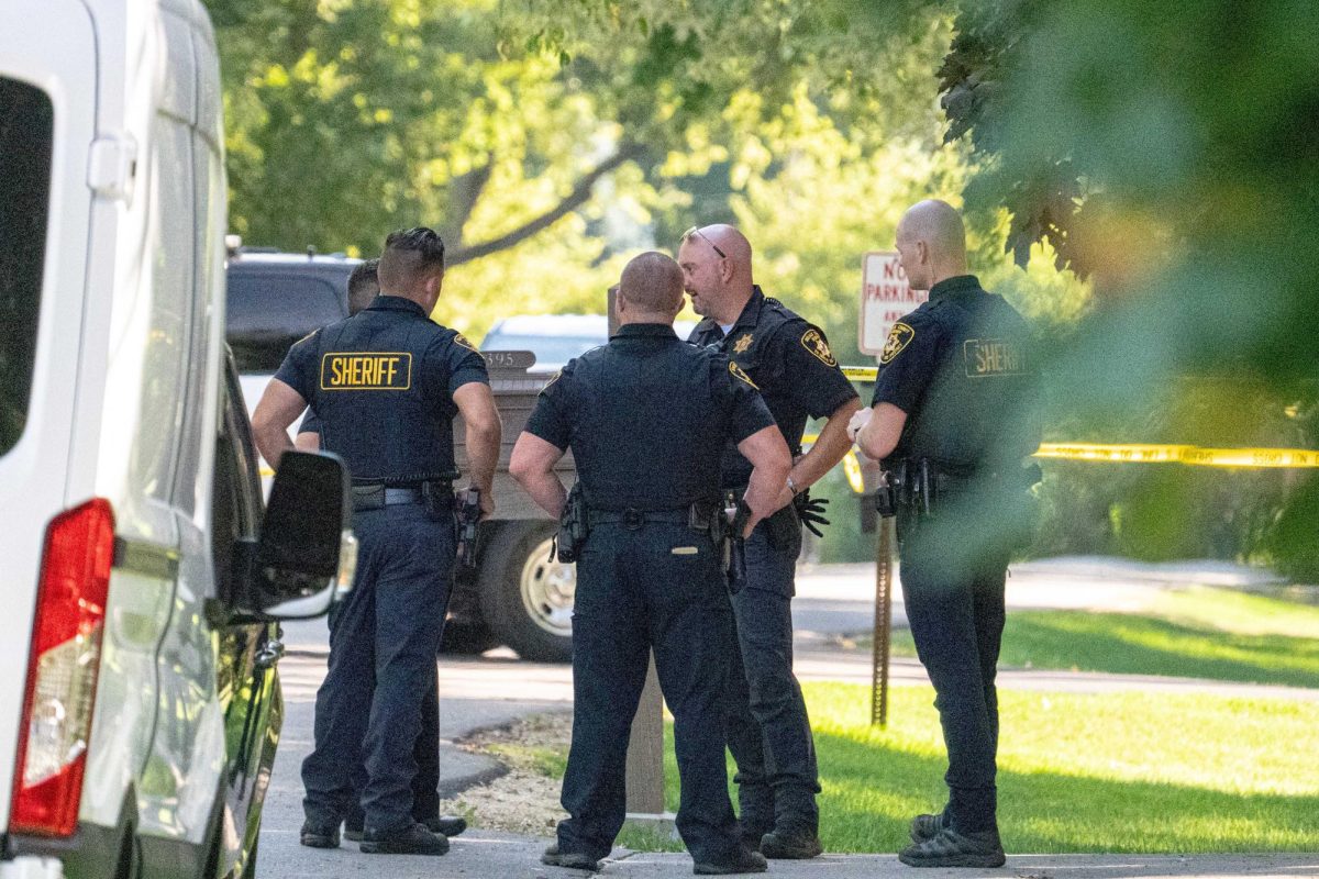 Members of the DeKalb County Sheriff's Department huddle outside of 1392 Oakland Drive in unincorporated Sycamore, on Tuesday after two people were found dead in their residence. the investigation forced a nearly hour-long soft lockdown to Sycamore Community School District 427 schools. (Totus Tuus Keely | Northern Star) 