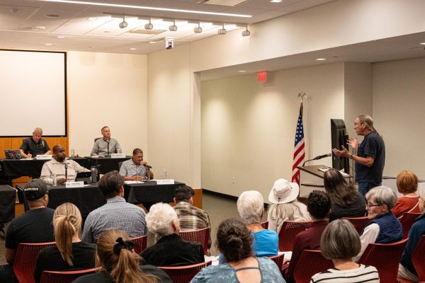 Dave Johnson, resident of Geneva and DeKalb property owner of 1504 Cambria Drive, questions the boutique data center mentioned in an information packet from the planning commission on Monday during a public hearing section of the general DeKalb City Council meeting. Donato Solar plans to build a solar field farm and 12,000 square feet of data storage buildings between Challenger Drive and Greenwood Acres Drive as well as North Peace Road and Cambria Drive. (Totus Tuus Keely | Northern Star)