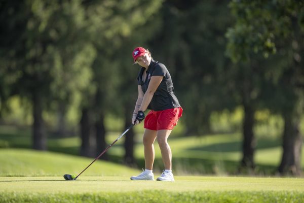 NIU women’s golf freshman Emily Chile lines up the club at the Redbird Invitational, hosted by Illinois State University. Three Huskies finished in the top-25 of the tournament, the first of the season for NIU.  (Courtesy of NIU Athletics)