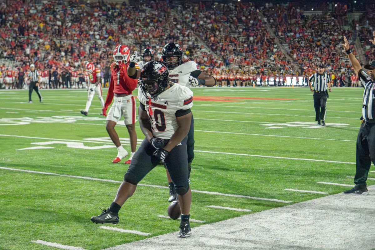 NIU football redshirt senior running back Chavon Wright (10) celebrates a first down against the University of Maryland on Sept. 5 in College Park, Maryland. The Northern Star Sports staff shares their predictions for the outcomes of five college football games scheduled to take place this weekend. (Totus Tuus Keely | Northern Star)