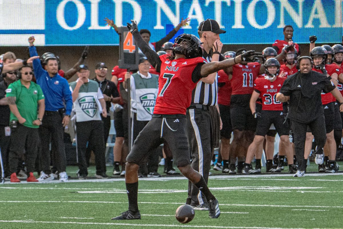 Senior cornerback Donte Harrison (7) reaches his arms to the sky to celebrate an incomplete pass in the final two minutes of the fourth quarter on Saturday against the College of the Holy Cross. NIU led the rushing game with 178 yards compared to Holy Cross’s 62, but fell behind in passing with 109 yards to 155. (Totus Tuus Keely | Northern Star)