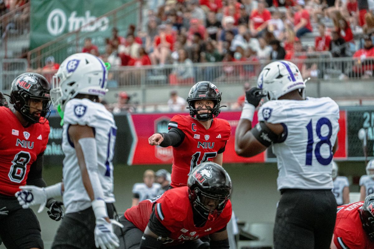 NIU redshirt sophomore quarterback Josh Holst (15) points from the line of scrimmage during the first quarter of NIU's season opener against Holy Cross on Saturday at Huskie Stadium. Holst will make his fifth career start Friday, when the Huskies face the University of Maryland Terrapins at SECU Stadium in College Park, Maryland. (Totus Tuus Keely | Northern Star)