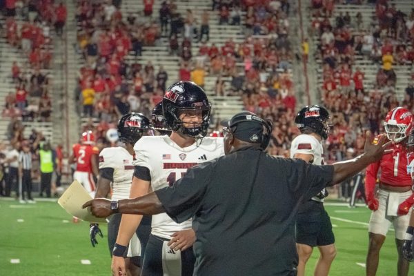 NIU football head coach Thomas Hammock shouts at redshirt sophomore quarterback Josh Holst (15) near the sideline after Holst committed an intentional grounding penalty in the fourth quarter of the Huskies’ road opener against the University of Maryland on Friday night at SECU Stadium in College Park, Maryland. Holst finished 14-of-22 passing for 91 yards and no touchdowns. (Totus Tuus Keely | Northern Star)