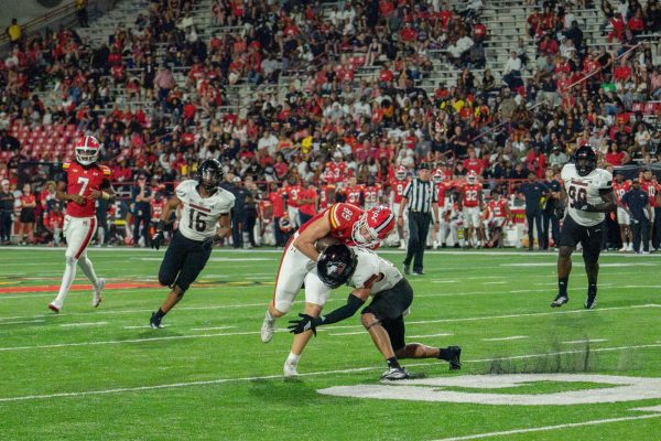 Junior safety Jasper Beeler (22) takes out University of Maryland junior tight end Aj Szymanski’s (89) legs in the fourth quarter Friday at SECU Stadium in College Park, Maryland. NIU will return home on Sept. 27 against future fellow conference member, Diego State University of the Mountain West Conference. (Totus Tuus Keely | Northern Star)