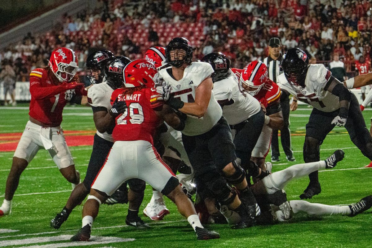 NIU redshirt junior left tackle Evan Malcore (54) throws a block against University of Maryland freshman defensive lineman Sidney Stewart (29) during the fourth quarter of NIU's road opener on Friday night at SECU Stadium in College Park, Maryland. Pro Football Focus graded Malcore as one of the Huskies' top offensive players for the game. (Totus Tuus Keely | Northern Star)