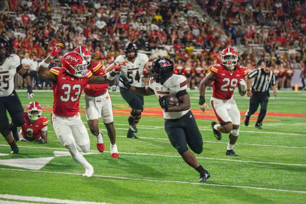 NIU redshirt senior running back Chavon Wright rushes past University of Maryland freshman defensive back Messiah Delhomme (33) during the second quarter of NIU's road opener on Sept. 5 at SECU Stadium in College Park, Maryland. Senior Sports Reporter Skyler Kisellus picked Wright as NIU's top offensive performer through two games. (Totus Tuus Keely | Northern Star)