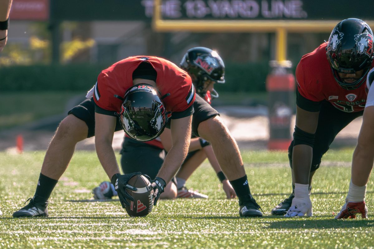 Senior long snapper Ross Pedro (44) lines up on the ball to hike the ball back for a 31 yard field goal in the first quarter on Saturday. NIU and San Diego State University only scored by field goals with a perfect completion rate. (Totus Tuus Keely | Northern Star)
