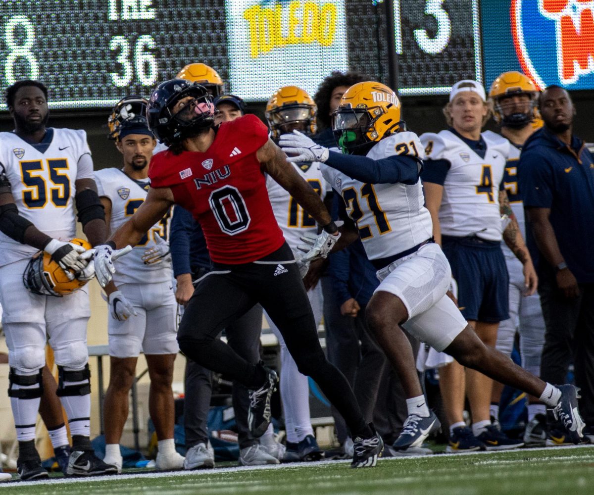 NIU then-redshirt sophomore wide receiver Cam Thompson (0) runs a route against University of Toledo then-junior defensive back Nasir Bowers (21) during NIU's 117th Homecoming game against the Rockets on Oct. 19, at Huskie Stadium in DeKalb. Thompson transferred to Mississippi State University after the 2024 season and has not recorded any statistics for the Bulldogs through the first three games of 2025. (Tim Dodge | Northern Star)