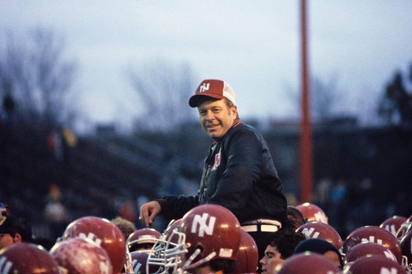 Then-NIU football head coach Bill Mallory is lifted by his players on an unknown date and at an unknown location. Mallory coached the Huskies from 1980 to 1983, leading them to a 25-19 record, their first Mid-American Conference title and a California Bowl victory. (Courtesy of NIU Athletics)