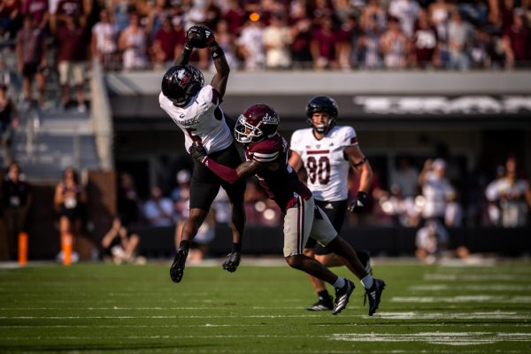 NIU junior wide receiver DeAree Rogers (6) makes a leaping catch over Mississippi State University redshirt senior safety Hunter Washington during the second quarter of Saturday’s non-conference football game at Davis Wade Stadium in Mississippi State, Mississippi. Rogers finished with six receptions for 84 yards and a touchdown in the Huskies’ 38-10 loss. (Courtesy of NIU Athletics)