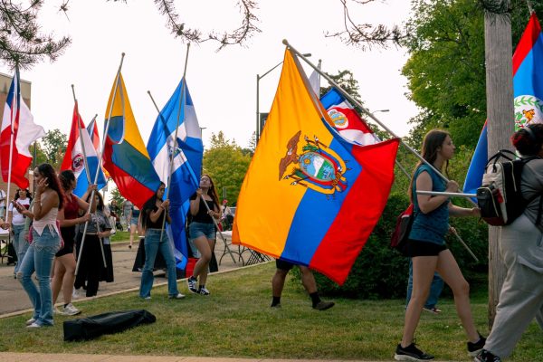 People march to the Latino Resource Center with flags from Latino countries on Thursday for the Latino Heritage Month Opening Parade. The march began at MLK Commons at 4 p.m. and marched to El Grito on Newman Lane outside of the Latino Resource Center. (Totus Tuus Keely | Northern Star)