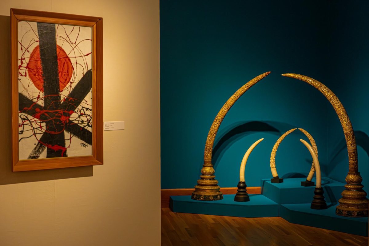Carved ivory tusks from the 19th century (right) and a painting titled “Art Burmese Dictatorship” from 1966 are on display at the “Legacies on Display: The Forbidden and Venerated Arts of Burma” gallery in the west end of the first floor of Altgeld Hall. The exhibit is open 10 a.m. to 1 p.m. on Wednesdays, noon to 6 p.m. on Thursdays and Fridays and noon to 3 p.m. on Saturdays until May 9. (Totus Tuus Keely | Northern Star)