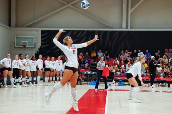 NIU volleyball sophomore setter Ella Strausberger (2) serves the ball during the Huskies’ match against Central Michigan University on Thursday. The Huskies won their third straight match against Eastern Michigan University on Friday, going 2-0 in Mid-American Conference play. (Marco Alvarez | Northern Star)