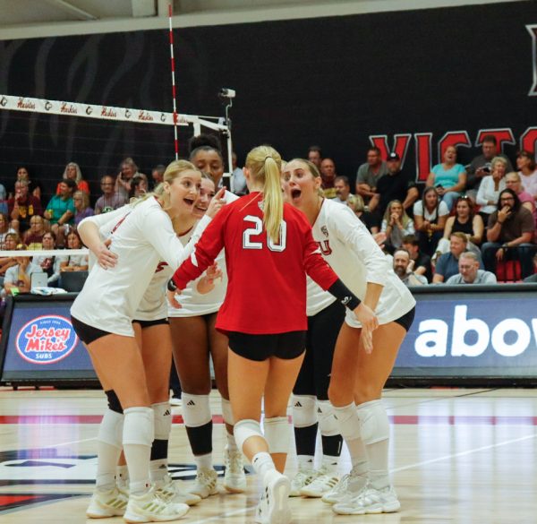 Members of the NIU volleyball team celebrate a point during their first conference match against Central Michigan University on Thursday. The Huskies staged a comeback after losing the first two sets to defeat the Chippewas. (Marco Alvarez | Northern Star)