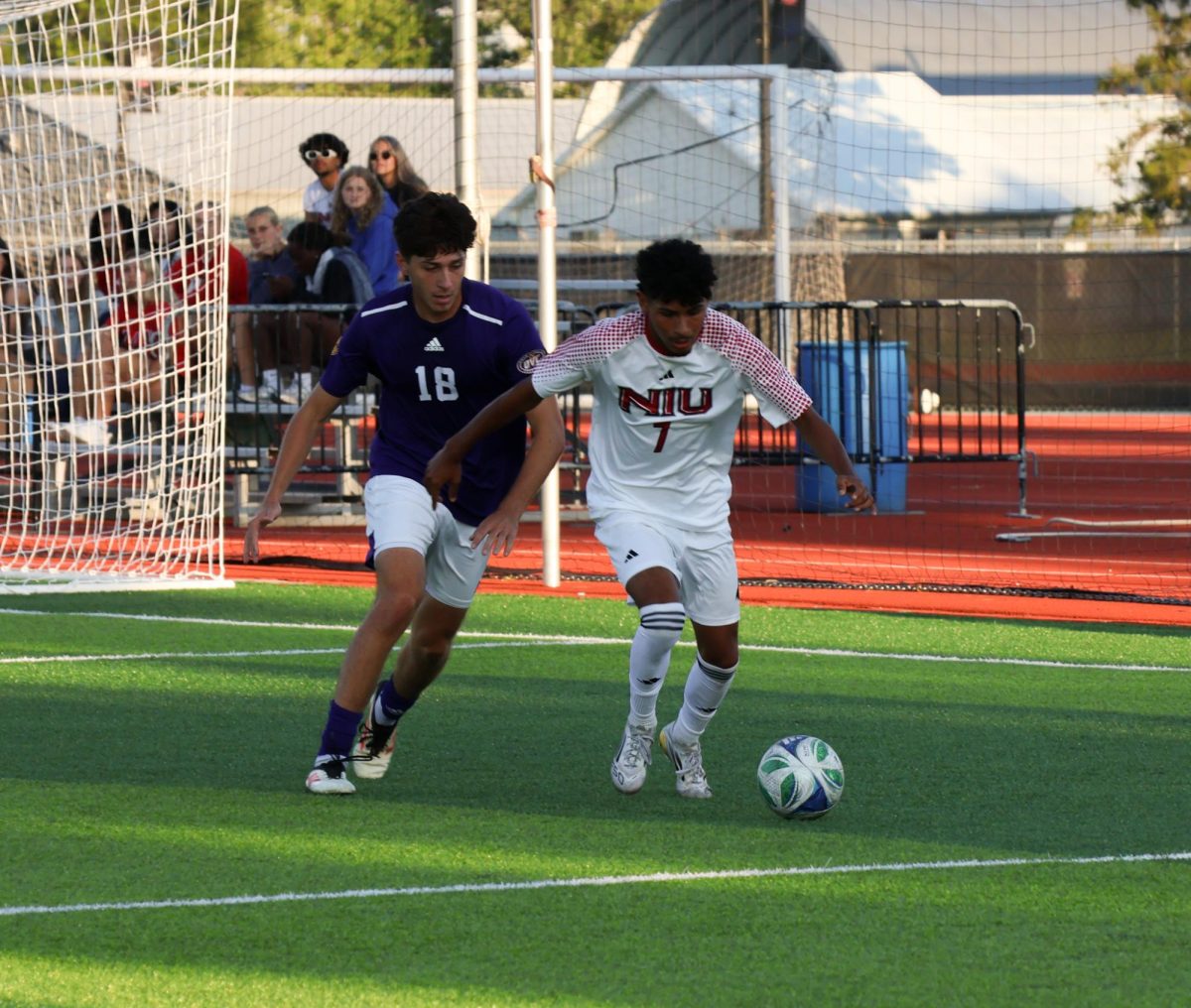  Freshman forward Tobias Crear (7) dribbles the ball away from Western Illinois University senior defender Gabriel Velasco (18) from. He successfully defended his goal by dribbling the ball away. (Alexia Beck | Northern Star)