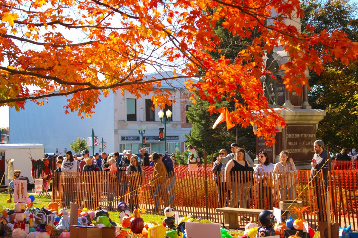 Attendees of the 2024 Sycamore Pumpkin Fest look at the pumpkin display. Every year, residents of the Sycamore area are invited to decorate or carve pumpkins for the festival's display. (Ethan Rodriguez | Northern Star) 