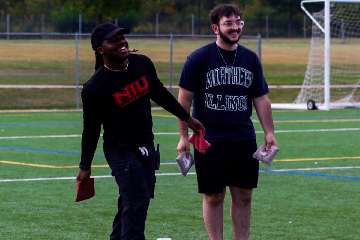 Sophomore kinesiology major Jerome Thomas (left) and first-year pre-physical therapy major Zyler Bragg play a game of bean bag toss at Rec Fest on Friday. Rec Fest was held at the NIU Recreation Sports Complex Between 5 p.m. to 9 p.m. (Marco Alvarez | Northern Star)