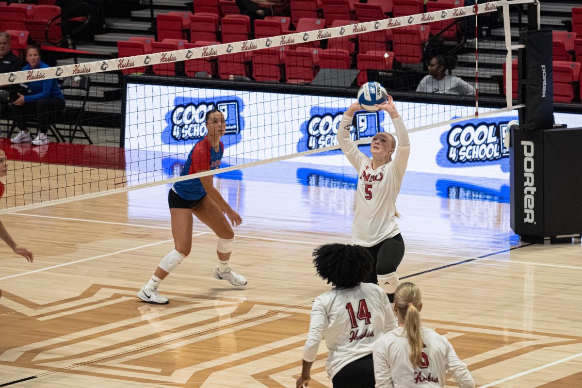 NIU volleyball redshirt junior setter Kylie Schulze (5) makes an assist on the ball during NIU’s exhibition match against DePaul University on Aug. 22. The Huskies split their matches on Friday, with Schulze leading the team in assists during both. (Totus Tuus Keely | Northern Star)