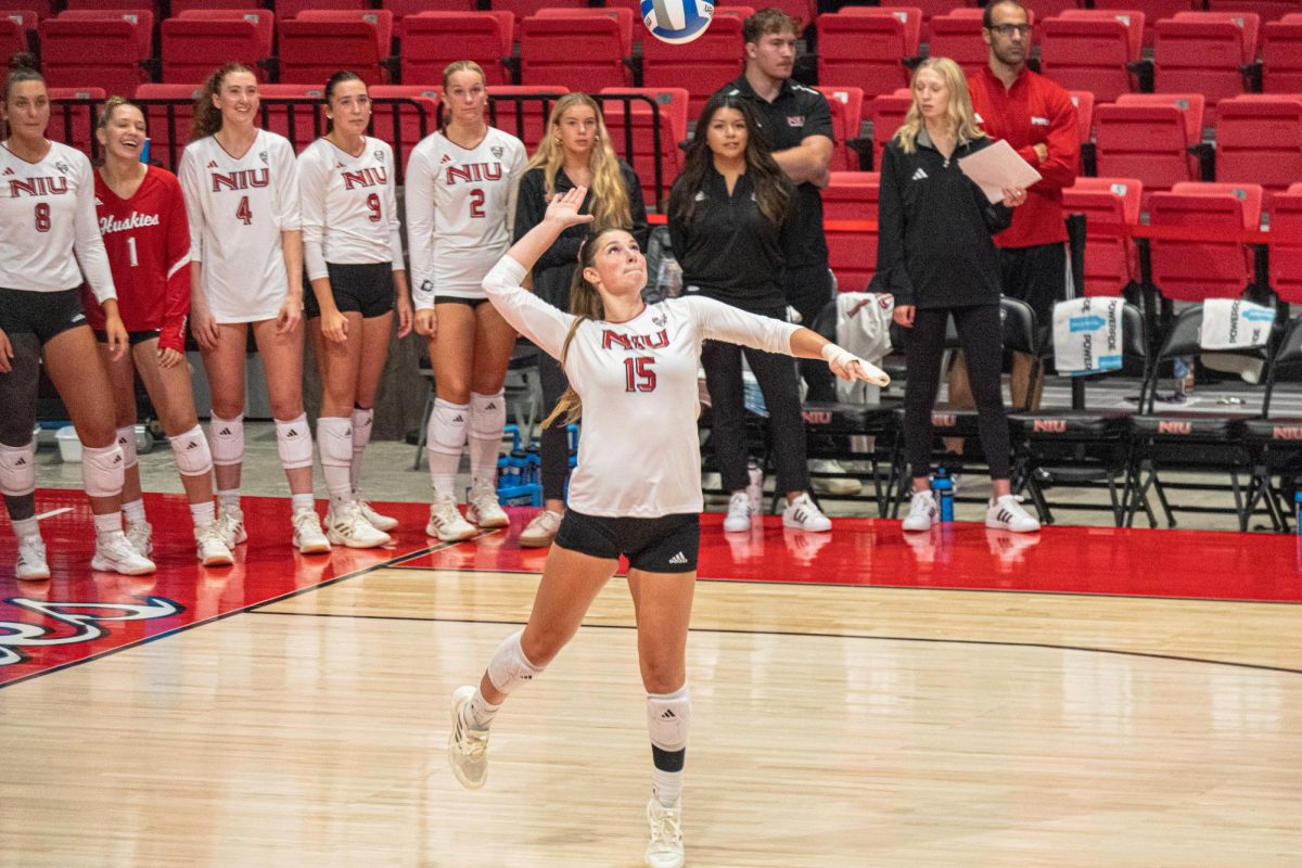 NIU volleyball junior middle blocker Autumn Flynn (15) serves the ball during NIU’s exhibition match against DePaul University on Aug. 22. Flynn recorded the match-winning ace in the Huskies' 3-2 defeat of Indiana University Indianapolis on Saturday to round out competition at the Hampton Inn Invitational. (Totus Tuus Keely | Northern Star)