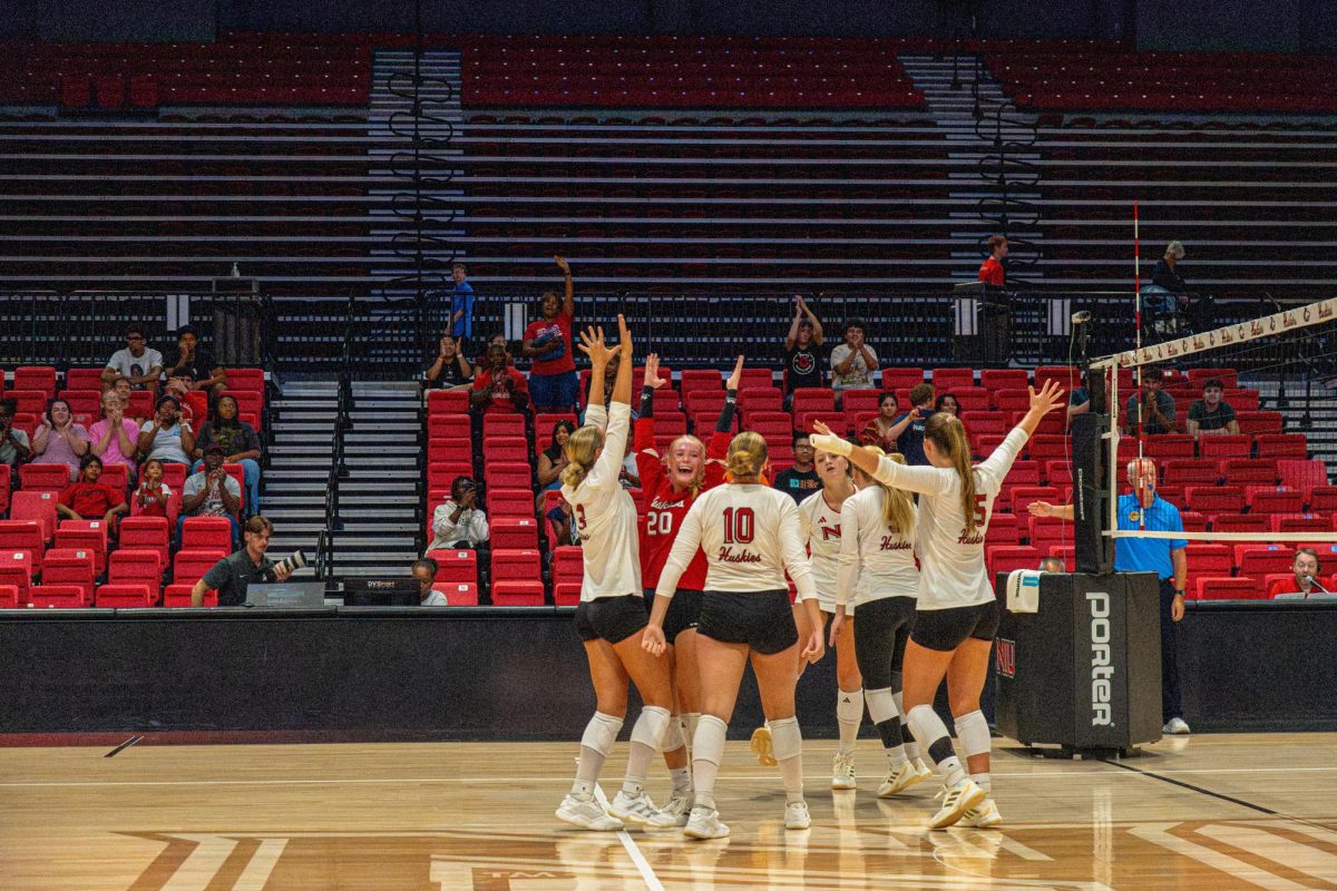 The NIU Volleyball team cheers after being awarded a point during an exhibition match against DePaul University on Aug. 22. The Huskies were undefeated at the NIU Invitational, with their third win coming in a 3-0 sweep of the Southern Illinois University Edwardsville Cougars on Saturday. (Totus Tuus Keely | Northern Star)