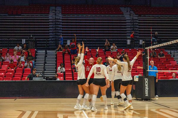 The NIU Volleyball team cheers after being awarded a point during an exhibition match against DePaul University on Aug. 22. The Huskies were undefeated at the NIU Invitational, with their third win coming in a 3-0 sweep of the Southern Illinois University Edwardsville Cougars on Saturday. (Totus Tuus Keely | Northern Star)