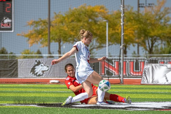 Freshman forward Mya Newcombe (2) attempts to push past Miami University junior forward Katie O’Malley’s (15) tackle in the second half of Sunday’s match at the NIU Track and Field & Soccer Complex. NIU began their MAC play with a 2-0 loss against Miami University. (Totus Tuus Keely | Northern Star)