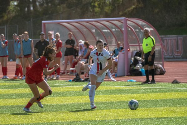 NIU women’s soccer senior forward Kelsi McLaughlin (4) drives the ball downfield during the second half of the Huskies’ match against Miami University on Sunday. The Huskies earned their first conference points on Thursday in a 1-1 draw with the University of Toledo. (Totus Tuus Keely | Northern Star)