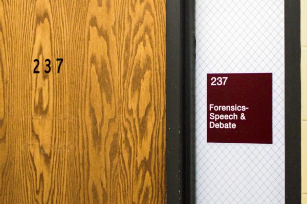 The sign for the NIU forensics meeting room hangs on the room's window. NIU forensics, founded in 1928, brings together students interested in public speaking and debate at NIU. (Ethan Rodriguez | Northern Star) 
