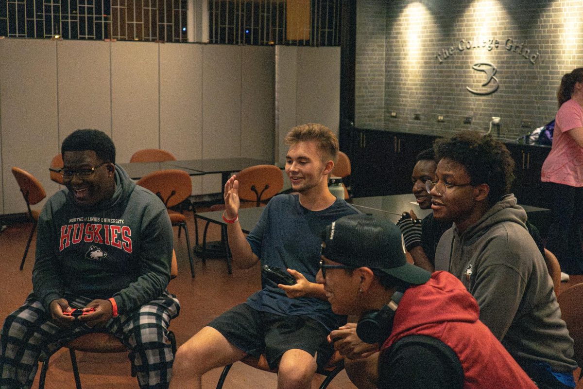 Students play “Super Smash Bros. Ultimate” on Aug. 23 at the College Grind in the Holmes Student Center for Welcome Holmes. The Holmes Student Center is one of the places NIU offers for students to connect with others. (Totus Tuus Keely | Northern Star)