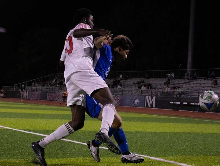 NIU men's soccer sophomore forward Katai Mukuka (40) gets boxed out by Eastern Illinois University fifth year defender Kento Tani (25) on Tuesday. The Huskies fell to the Panthers by a score of 3-2, their second straight loss. (Alexia Beck | Northern Star)
