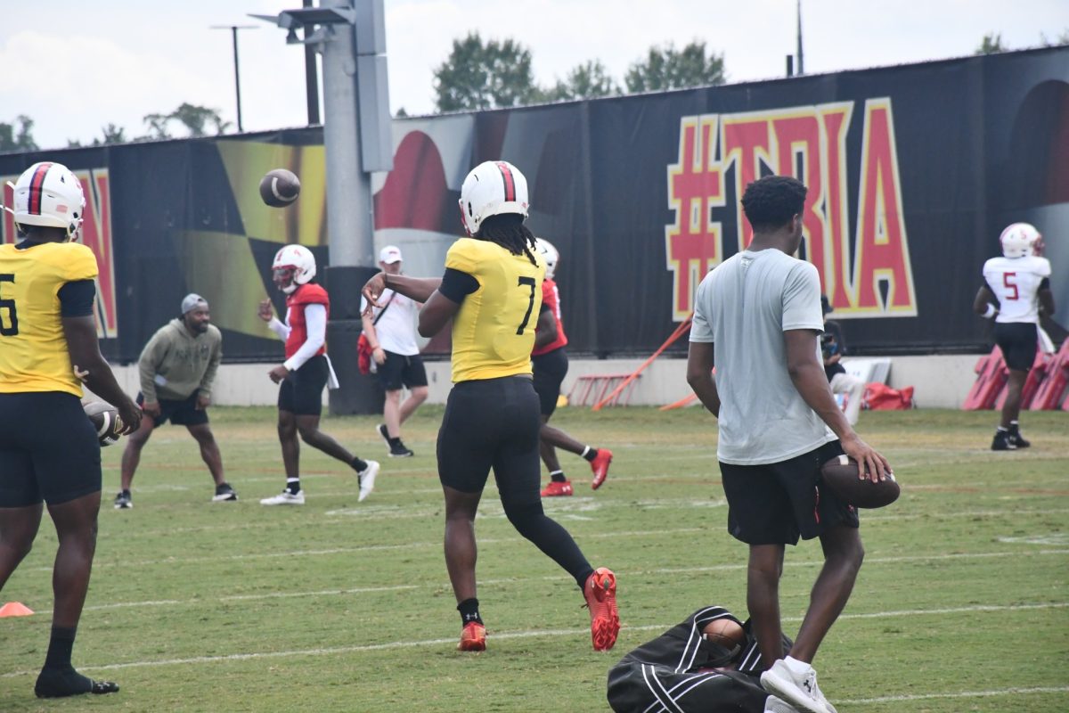 Maryland freshman quarterback Malik Washington (7) throws a pass during practice on Aug. 13 at the outdoor practice fields near Jones-Hill House in College Park, Maryland. Washington will make his second career start Friday against NIU. (Michael Howes | The Diamondback)