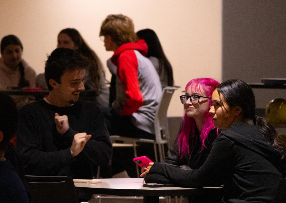 First-year pre-music major Marley Kershaw (from left), first-year elementary education major Jasmine Nemeth and first-year sociology major Iris Earll play trivia on Tuesday during Huskie Den Trivia Night in the Holmes Student Center. The trivia question categories consisted of famous haunted places, taco Tuesday, Halloween candy, and animals. (Alexia Beck | Northern Star)