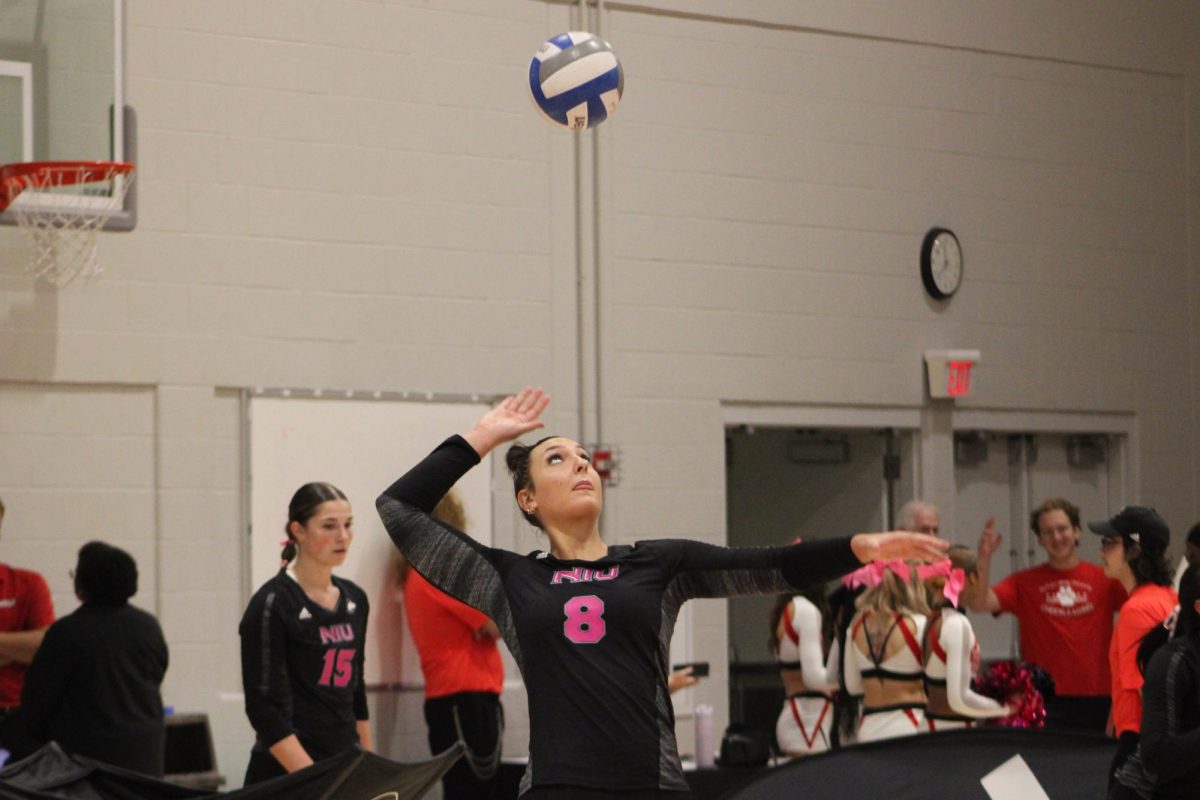 NIU volleyball sophomore middle blocker Rylea Alvin (8) serves the ball during the Huskies’ match against the University of Toledo on Oct. 17. The Huskies dropped a five-set battle to the University of Akron on Friday, falling 3-2. (Ethan Rodriguez  | Northern Star)