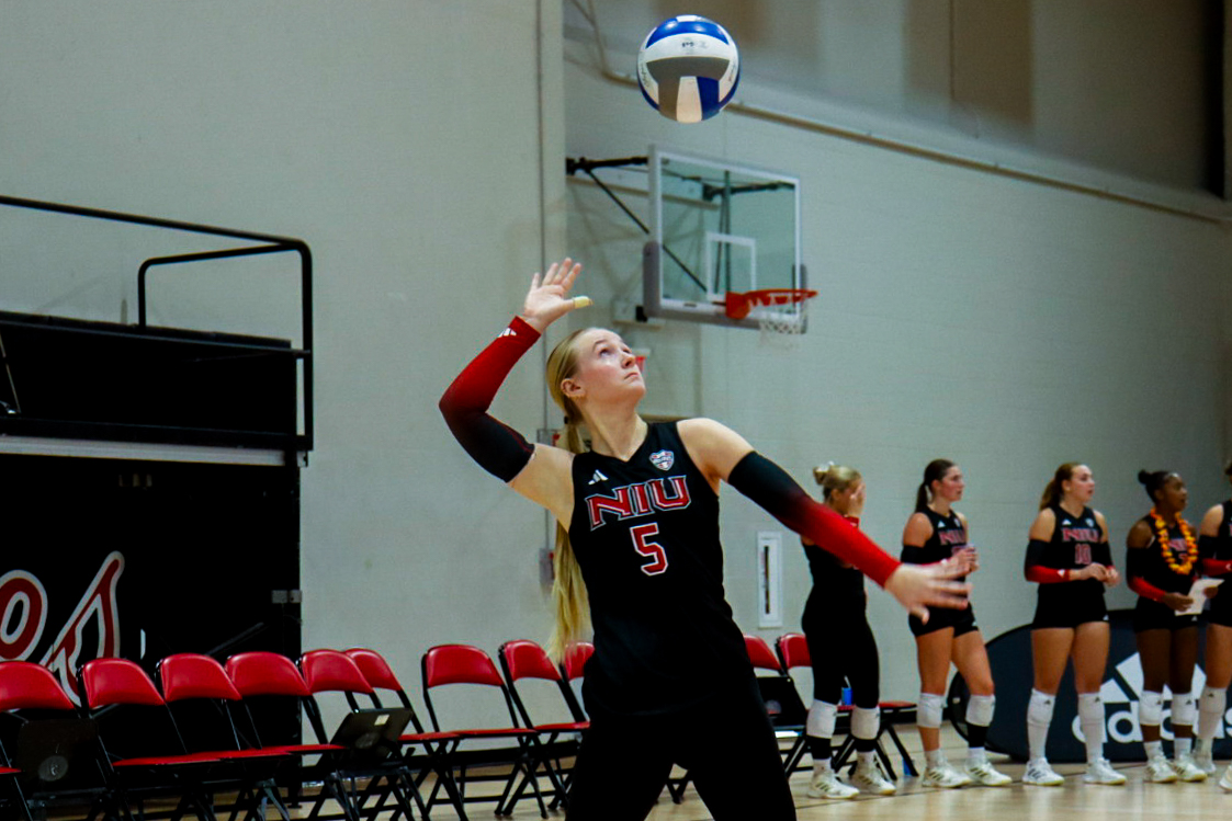 NIU volleyball redshirt junior setter Kylie Schulze (5) serves the ball during the Huskies’ match against Western Michigan University on Oct. 7. The Huskies fell to Bowling Green State University for the second straight game on Friday, getting swept in straight sets. (Marco Alvarez | Northern Star)