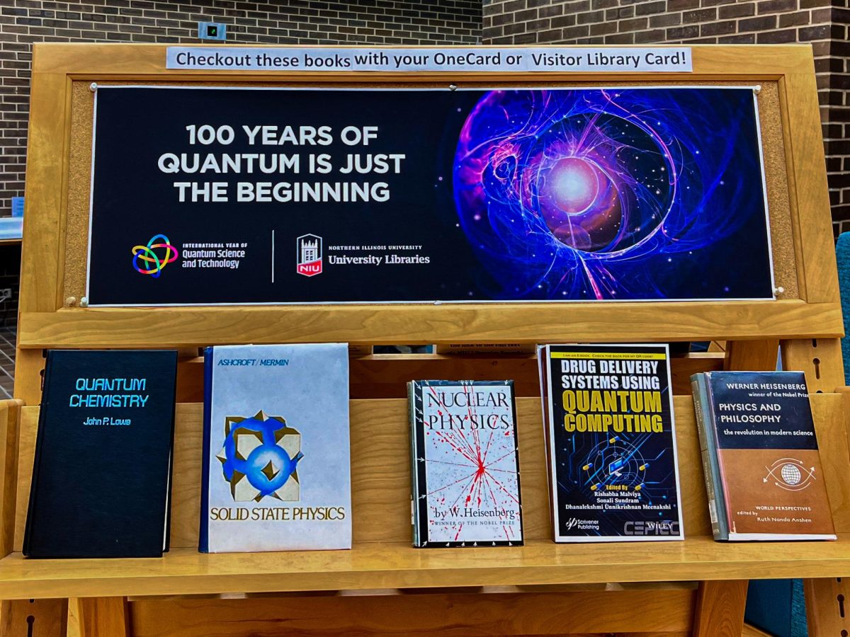 A book display highlights works on quantum physics, solid state physics, nuclear physics, quantum computing and philosophy in physics on the main floor of the Founder’s Memorial Library for the “100 Years of Quantum is Just the Beginning” exhibit. The year 2025 marks the 100th anniversary since the publication of the first papers on quantum physics. (Sofia Howell | Northern Star)