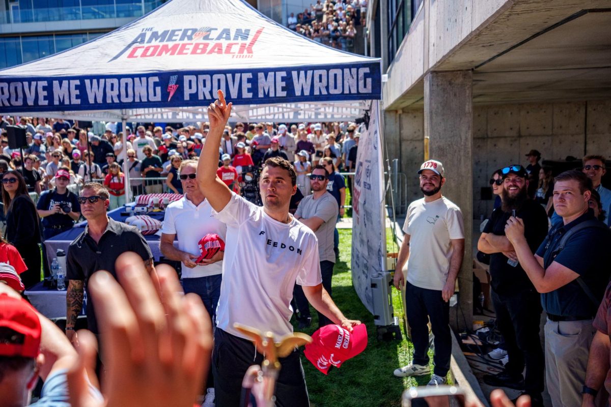 U.S. right-wing activist and commentator Charlie Kirk throws hats to the crowd shortly before he was fatally shot at a Utah Valley University speaking event in Orem, Utah, on Sept. 10. Opinion Columnist Lucy Atkinson believes that President Donald Trump blaming liberals for Kirk's death only perpetuates the cycle of violence. (Trent Nelson | The Salt Lake Tribune via REUTERS)