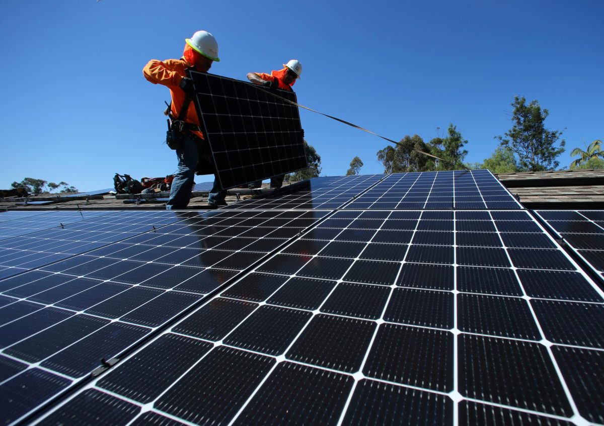 Solar installers place solar panels on the roof of a residential home in Scripps Ranch, San Diego, California. Opinion Columnist Byrdie Seda argues the DeKalb City Council shouldn't have voted against building a solar farm on Peace Road in DeKalb. (REUTERS | Mike Blake) 