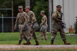 Texas National Guard troops walk around the Joliet Army Reserve Training Center in Elwood, Illinois. NIU students enlisted in the National Guard are activated along with students from other Illinois State schools by order from the Trump Administration. (Jim Vondruska | REUTERS)