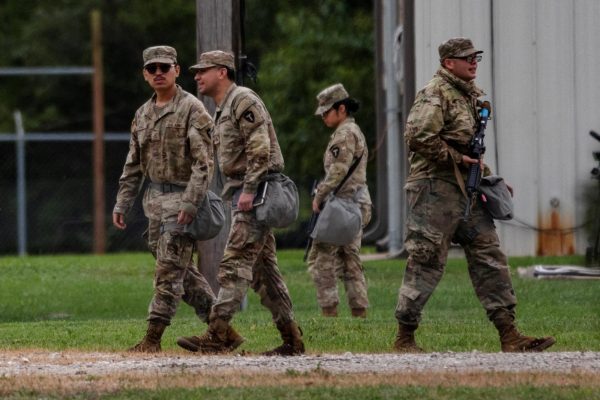 Texas National Guard troops walk around the Joliet Army Reserve Training Center in Elwood, Illinois. NIU students enlisted in the National Guard are activated along with students from other Illinois State schools by order from the Trump Administration. (Jim Vondruska | REUTERS)