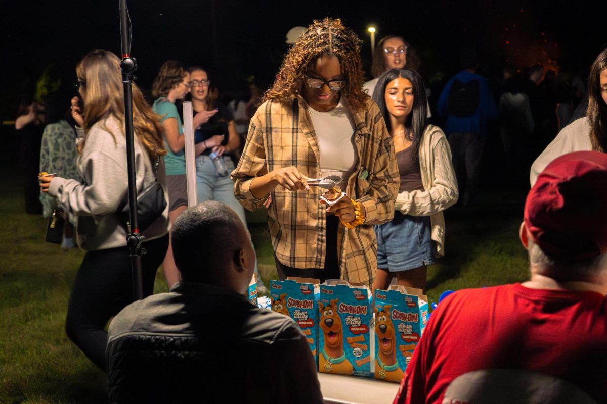 Omoye Osaremwinda, a senior engineering technology major, places Scooby Snacks into her chocolate pudding on Aug. 20 at Campfire Connections. The Leyendas and Myths Bonfire will take place from 4 p.m. to 5:30 p.m. Monday at the Outdoor Recreation Sports Complex. (Northern Star File Photo)