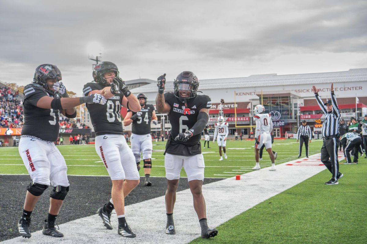 Junior wide receiver DeAree Rogers (6) celebrates in the south end zone after his touchdown in the fourth quarter against Ball State University on Saturday in Huskie Stadium. Rogers rushed 16 yards after a short pass to gain his touchdown. (Totus Tuus Keely | Northern Star)