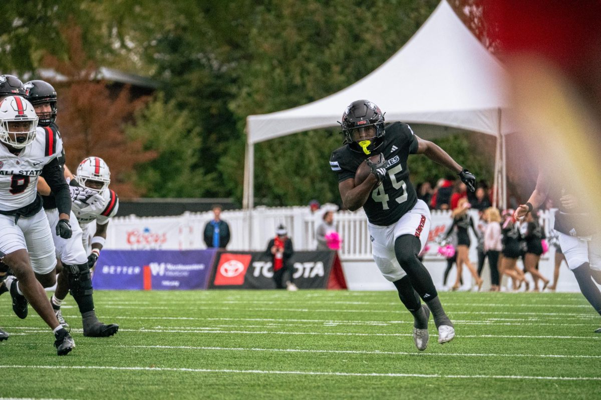 NIU sophomore running back Telly Johnson Jr. (45) rushes for a 53-yard touchdown during the first quarter of a football game on Saturday at Huskie Stadium in DeKalb. The run was Johnson's third touchdown run of 50 yards or longer this season. (Totus Tuus Keely | Northern Star)