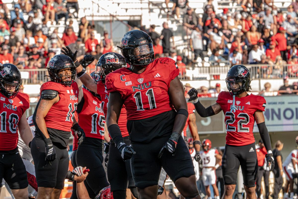 NIU redshirt senior defensive end Jalonnie Williams (11) celebrates after assisting a tackle on San Diego State University junior running back Lucky Sutton (not pictured) in the third quarter of Saturday's home football game at Huskie Stadium in DeKalb. The Huskies will host the Miami University RedHawks for their 118th Homecoming game on Saturday. (Northern Star file photo)