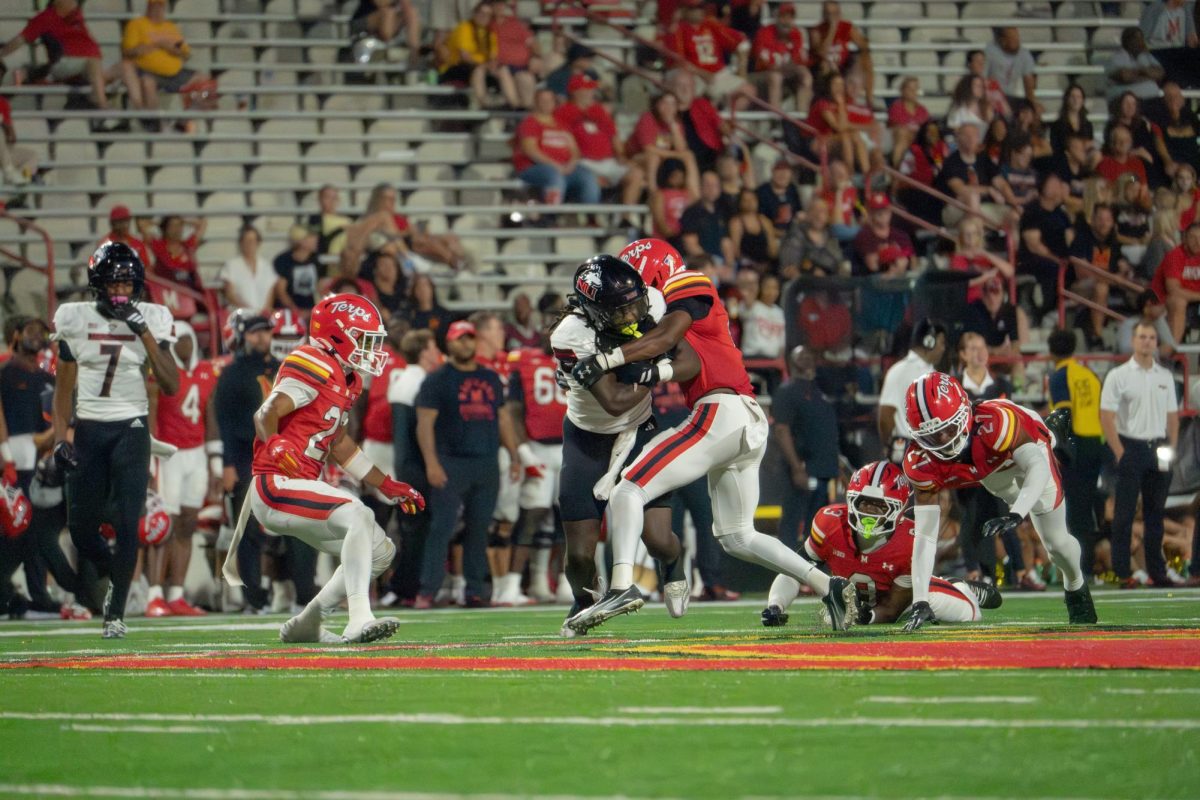 NIU football sophomore running back Telly Johnson Jr. (45) reaches a first down against the University of Maryland on Sept. 5 at SECU Stadium in College Park, Maryland. Johnson gave NIU a 10-6 lead against Eastern Michigan Saturday with an 80-yard rushing touchdown in the third quarter. (Northern Star File Photo)