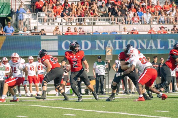 Freshman quarterback Brady Davidson (2) steps back to attempt a deep pass in the second quarter to redshirt freshman wide receiver La’Don Bryant (0) on Saturday in DeKalb against Miami University. NIU goes into halftime trailing Eastern Michigan University 6-3. (Northern Star File Photo)