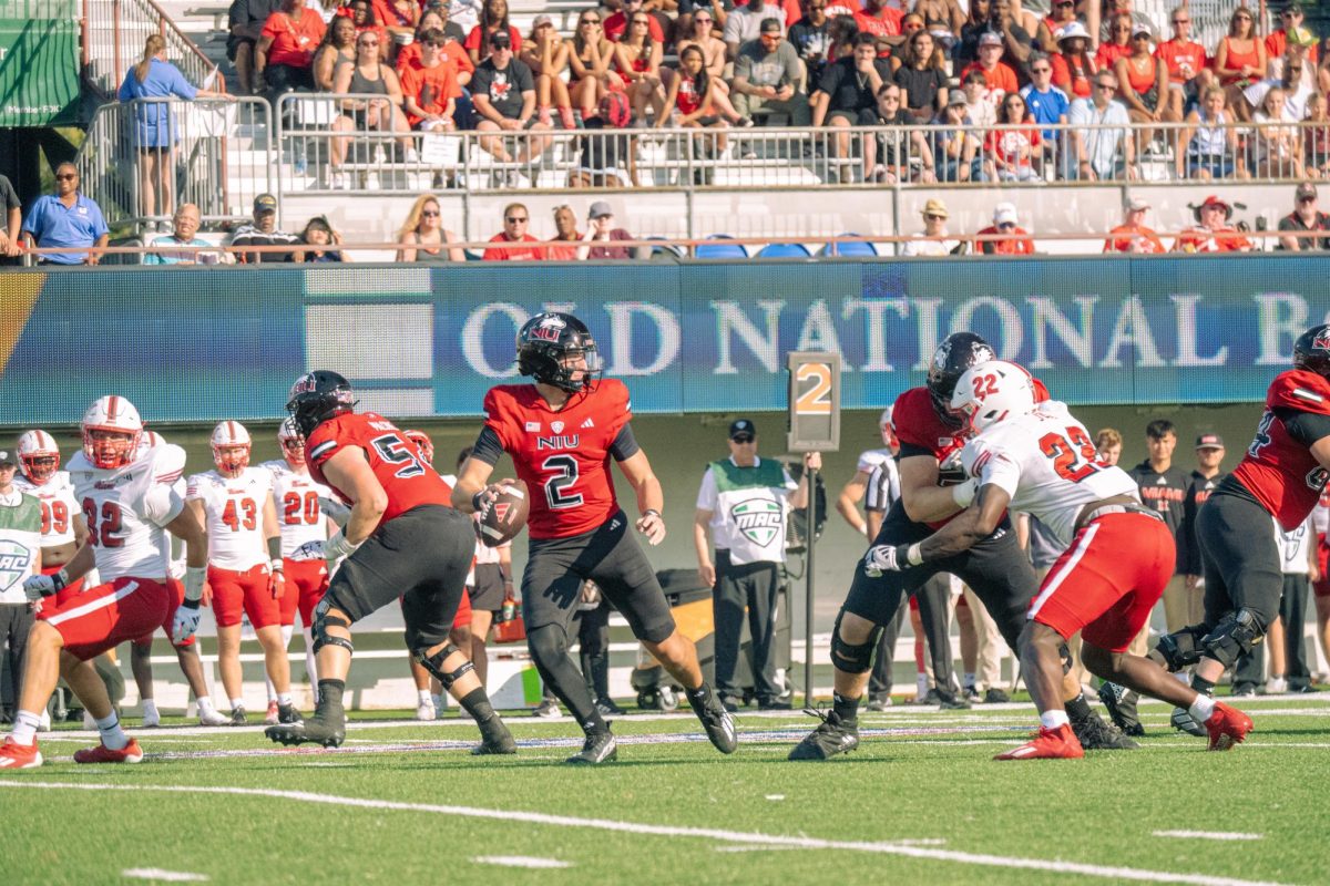 Freshman quarterback Brady Davidson (2) steps back to attempt a deep pass in the second quarter to redshirt freshman wide receiver La’Don Bryant (0) on Saturday in DeKalb against Miami University. NIU goes into halftime trailing Eastern Michigan University 6-3. (Northern Star File Photo)