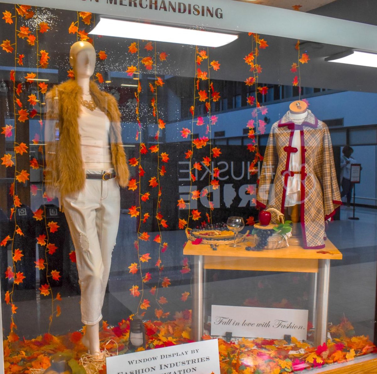 The Fashion Industries Organization's seasonal window in Wirtz Hall features two outfits surrounded by autumn leaves. Opinion Editor Kahlil Kambui ranks his favorite looks from Paris Fashion Week where top couture brands showed off their designs during the week of Sept. 29. (Grace Kilbreth | Northern Star)