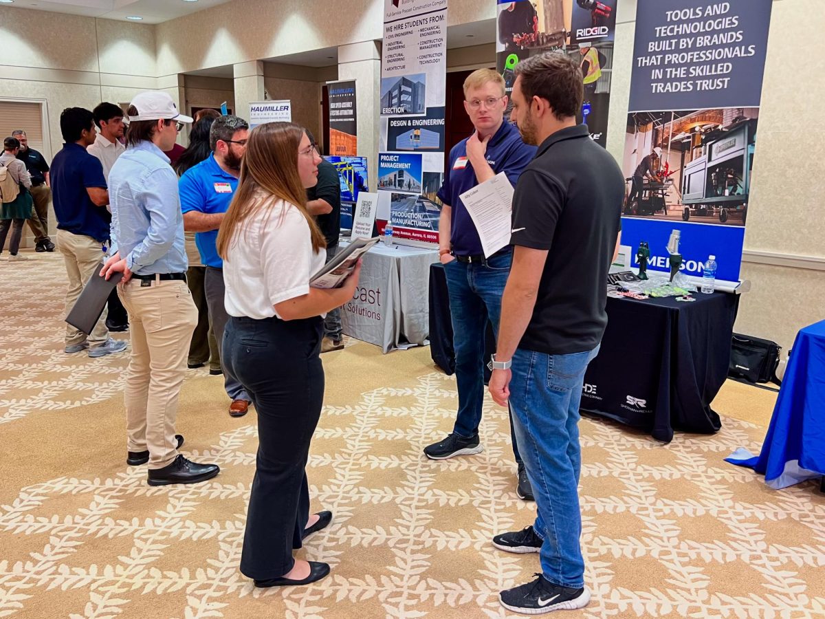 Ally Coker, a sophomore mechanical engineering major, (left) speaks with Emerson Mechanical II NPD Mindaugas Vaisys and Emerson Mechanical NPD Kris Mirjanic (right) about working with Emerson Electric Company on Tuesday at the College of Engineering and Engineering Technology Job and Internship Fair. Alumni and friends of NIU donated a total of $7.3 million to create the Barsema Alumni and Visitor’s Center. (Sofia Howell | Northern Star) 