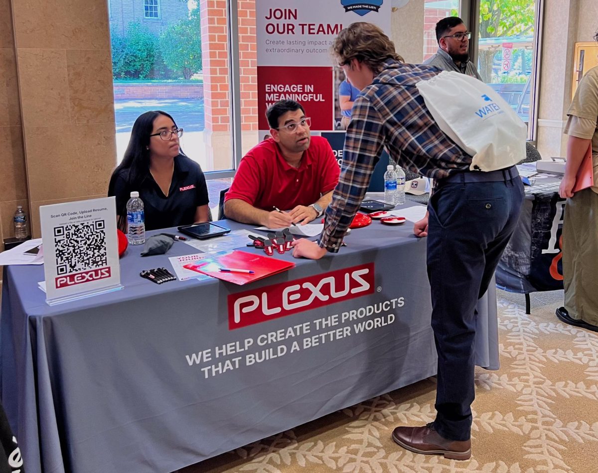 John Van Donsel, a senior mechanical engineering major, speaks with Plexus Mechanical II Achint Maniar (right) and Recruiter Nanci Catalan (left) about different options available through Plexus Electronic Manufacturer on Tuesday during the College of Engineering and Engineering Technology Job and Internship Fair. The Barsema Alumni and Visitor’s Center can host weddings, special events or celebrations through the eight different types of rooms as well as providing different catering services as well. (Sofia Howell | Northern Star) 